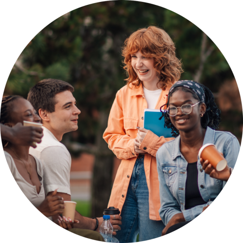 Four male and female students enjoying their day outside.