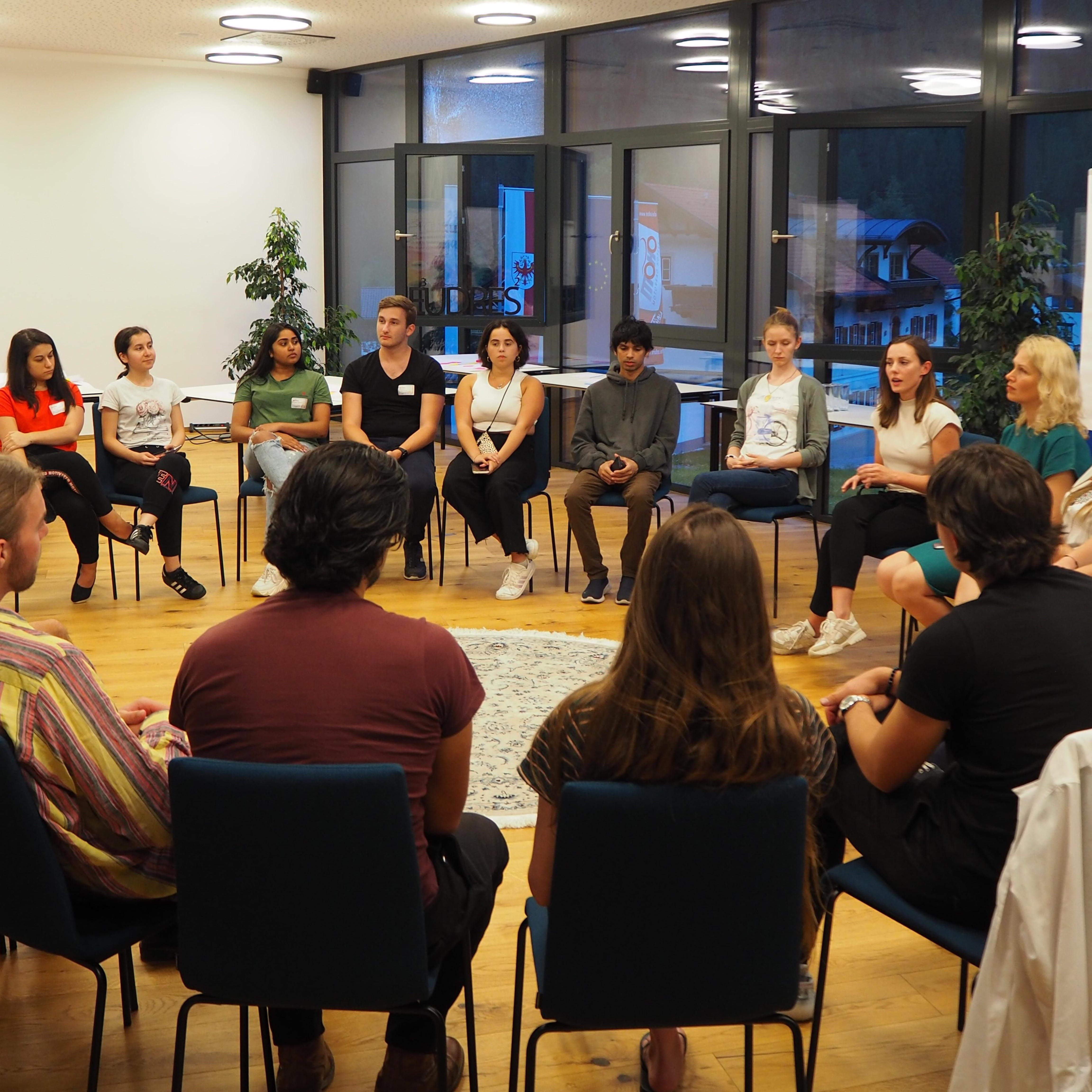 Photo of people discussing in a chair circle at the EU³DRES² Bootcamp